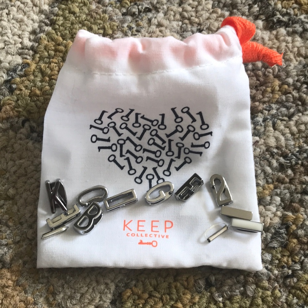 Assorted NEW Silver Charms from KEEP with bag.